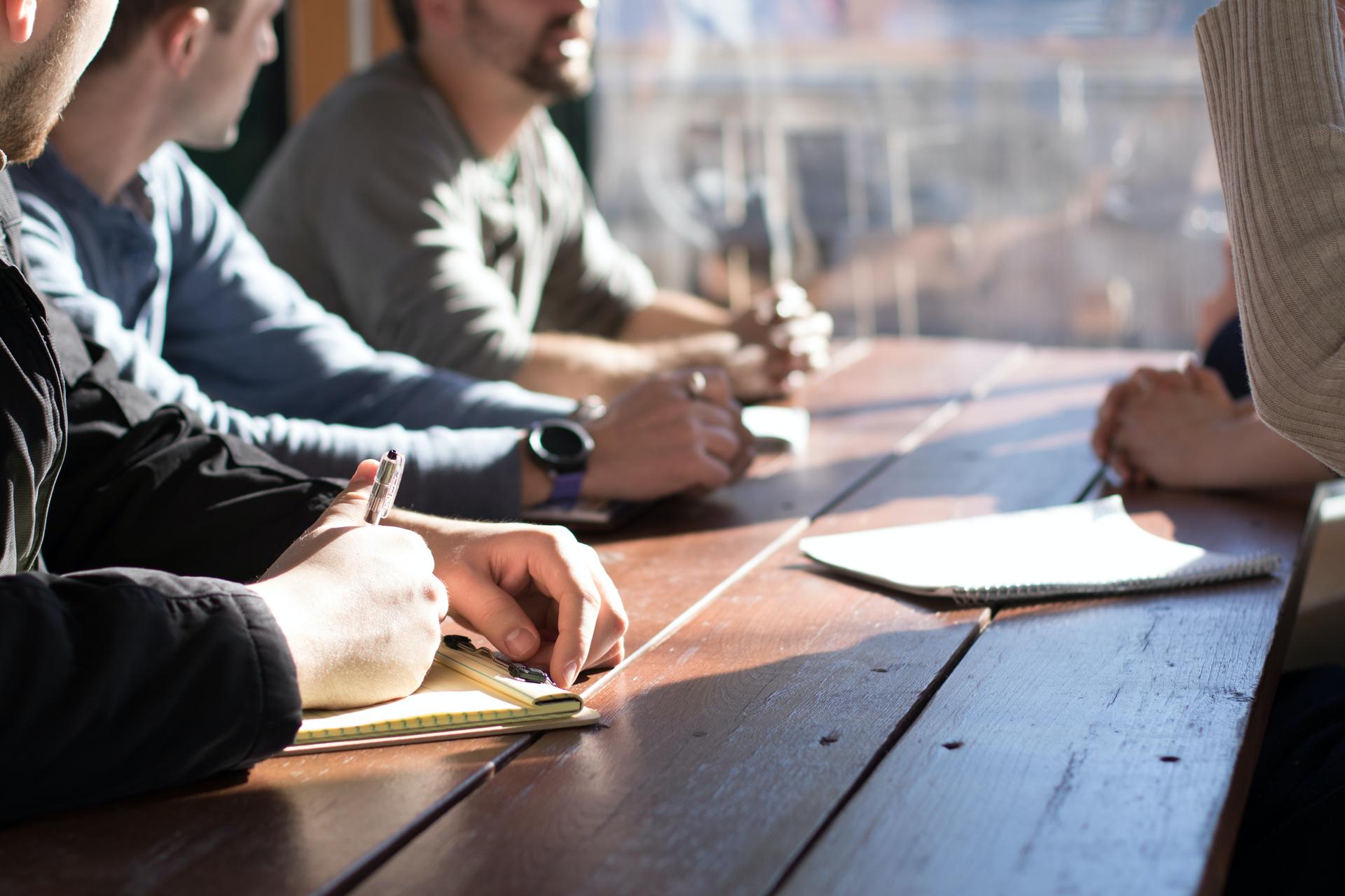 some people sitting during a meeting of the team.